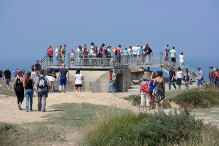 NORMANDY, FRANCE - JULY 2014  Visitors at Pointe du Hoc, during World War II it was the highest point between Utah Beach and Omaha Beach the prominent cliff top location was fortified by the Germansのeditorial素材