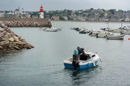 ERQUY, FRANCE - JULY 2014: A small recreational fishing boat sails into the harbor of Erquy, Cotes d Armor in Brittanyのeditorial素材