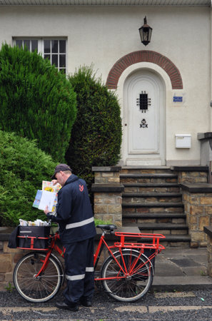 SPA, BELGIUM - AUGUST 2010: Belgian Postman, employee or bpost, also known as the Belgian Post Group, the Belgian company responsible for the delivery of national and international mail.のeditorial素材