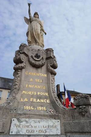 CARENTAN, FRANCE - JULY 2014: World War I memorial in the town of Carentan, Normandy, France. Memorial was built to commemorate victims of the Great War 1914 -1918 with added a plaque for World War II victimsのeditorial素材