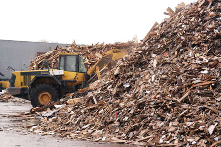Shovel accumulate a pile of wood chips for use as a biomass solid fuel.の写真素材