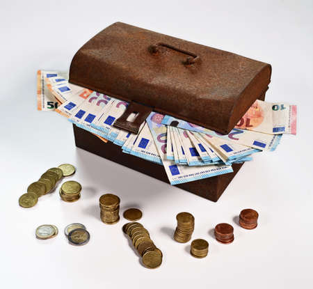 Old rusty cash box with Euro banknotes and coinsの写真素材