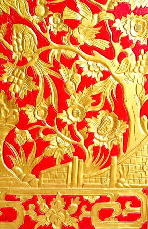 Golden dragon on red wood door の写真素材