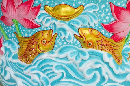 Fish with lotus statue in the wall. の写真素材