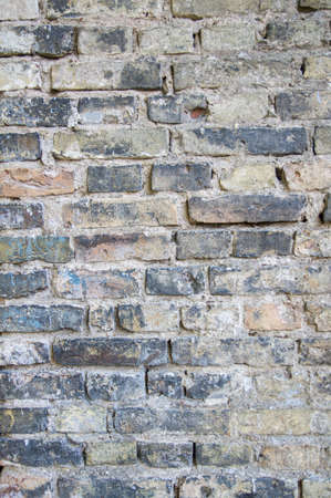 Grey white black red orange old vintage brick wall background. Rustic cemented brick house wall...