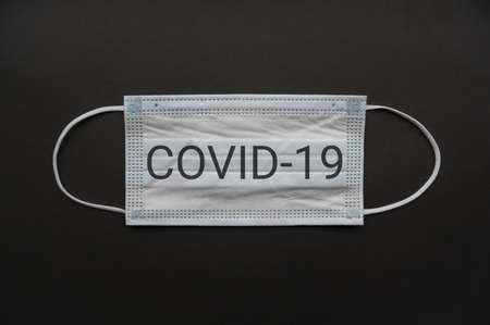 Medical mask isolated on background. Close-up of Coronavirus or COVID-19 protective face mask. Workwear prevents entry of Alpha, Beta, Gamma, Delta, Omicron into a body. Travel rules tightened overの写真素材