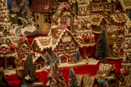 Advent Bazaar Stalls with glass, wooden, ceramic christmas souvenirs in a shop. Close up of festive decorations for tree in winter street night market during new year's holiday. Illuminated fair kioskの写真素材
