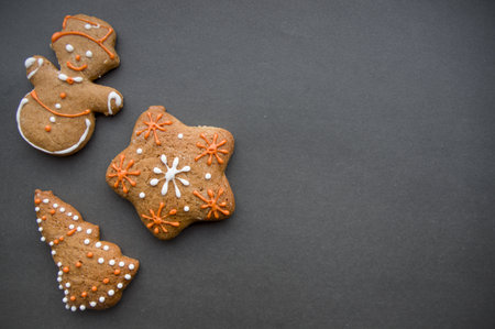 Set of different homemade Christmas cookies isolated on wooden background, close up view with copy space for text. New year frame with tasty gingerbread cookies with spices. Winter holiday conceptの写真素材