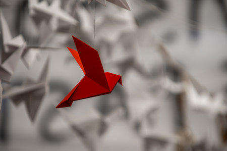 Japanese folded Origami cranes hanging on with strings. Hundreds handmade paper birds isolated with copy space. 1000 thousand crane tsuru sculpture topic. Symbol of peace, faith, health, wishes, hopeの写真素材
