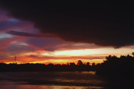 Beautiful sunset over the river. Colorful sky with clouds.の写真素材