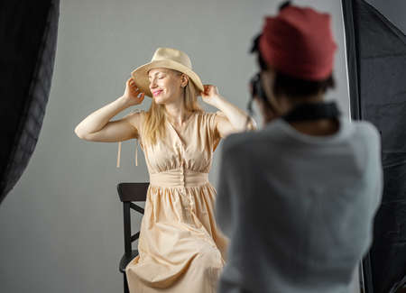 Female photographer shooting modelの写真素材