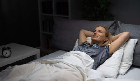 Smiling woman in bedroom