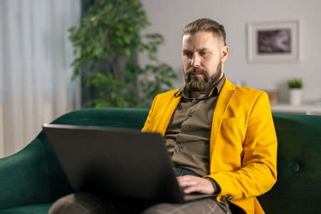 Man on couch with laptopの写真素材