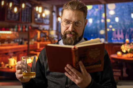 Man at cafe with bookの写真素材