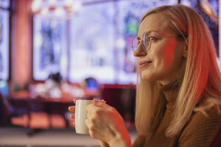 Dreamy woman at cafe