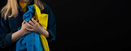 Woman holds ukrainian flagの写真素材