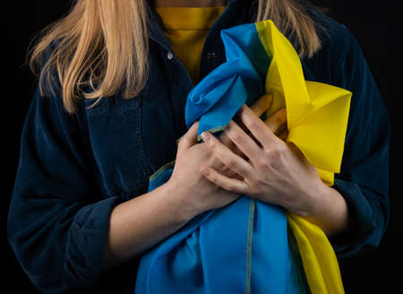 Woman holds ukrainian flagの写真素材