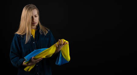 Woman holds ukrainian flagの写真素材
