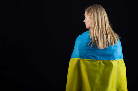 Woman holds ukrainian flagの写真素材