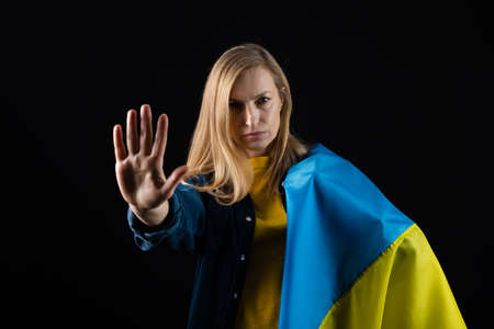 Woman holds ukrainian flagの写真素材