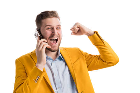 Excited male with smarthone raising arm