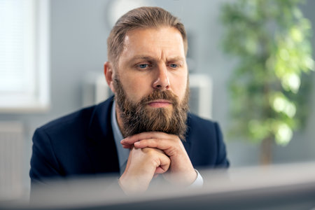 Thoughtful man working on pcの写真素材