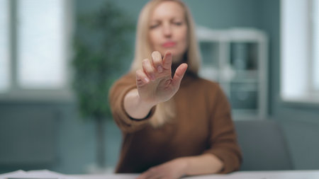 A woman is watching holographic screens.の写真素材