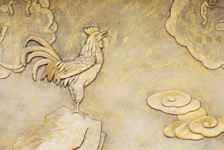 golden relief of rooste on rockの写真素材