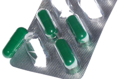 green capsule pill isolated on whiteの写真素材