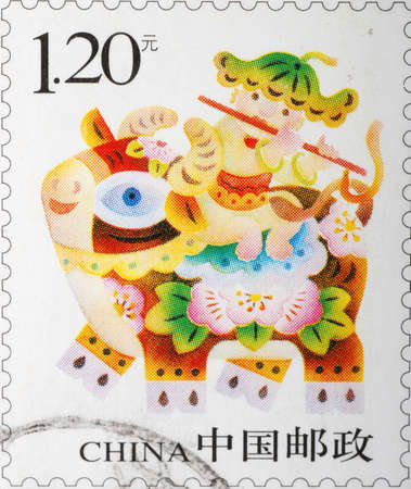 China - CIRCA 2009: A stamp printed in China shows a Chinese kid on buffalo, circa 2009の写真素材