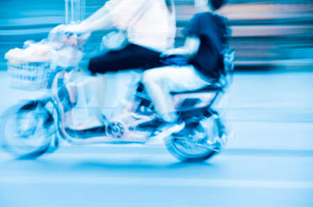 big city motor bicycle driver blur motionの写真素材