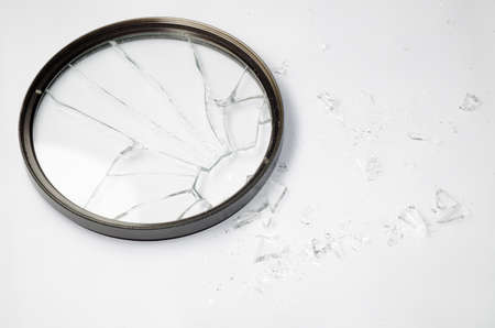 broken Dslr lens UV filter isolated on whiteの写真素材