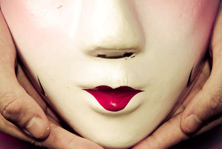 Chinese ancient opera mask in handの写真素材