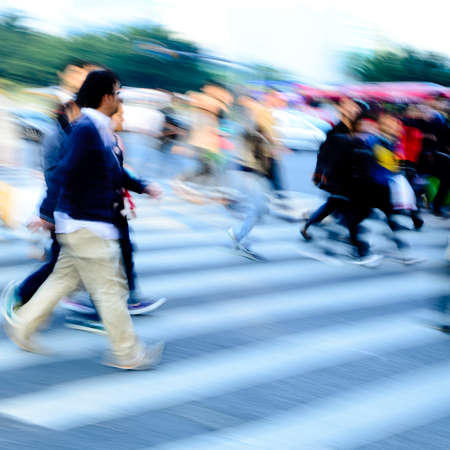 busy city people crowd on zebra crossing streetの写真素材