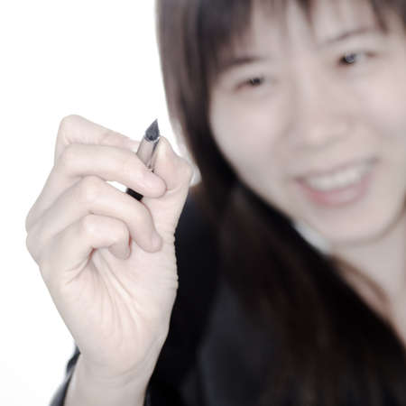 Asian business woman writing something with a pen isolated