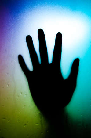 silhouette of hand with glassの写真素材