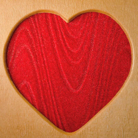 wood heart shape frame red backgroundの写真素材