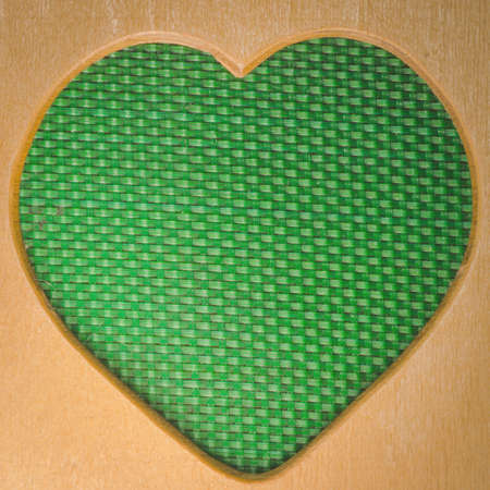 wood heart shape frame green backgroundの写真素材