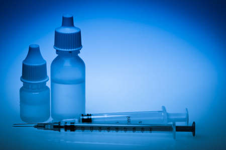 Packs of different medical pills and syringe backgroundの写真素材