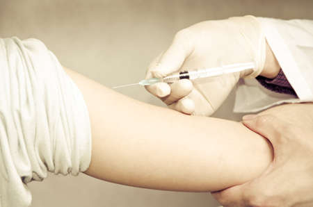 doctor injecting vaccination with patient handの写真素材
