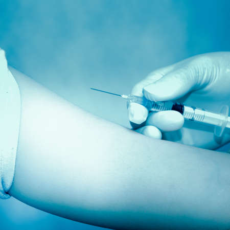 doctor injecting vaccination with patient handの写真素材