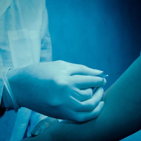 doctor injecting vaccination with patient handの写真素材
