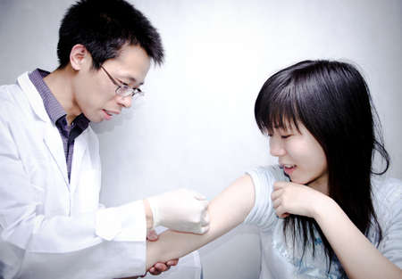 asian doctor injecting vaccination with patient hand