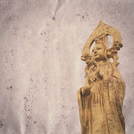 golden buddha statue old grunge paper texture backgroundの写真素材
