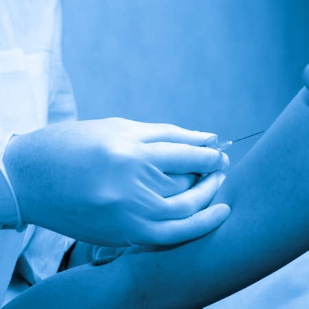 doctor injecting vaccination with patient hand