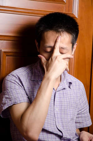 sad asian man on doorの写真素材
