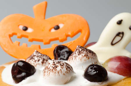 Halloween cake with pumpkin backgroundの写真素材