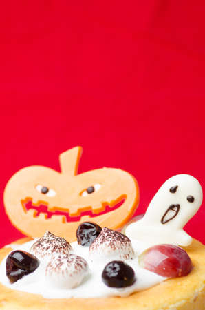 Halloween cake with pumpkin red backgroundの写真素材