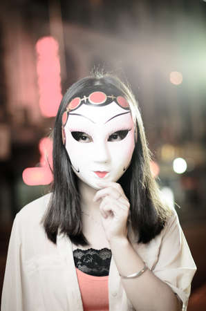 Asian women with Chinese mask at nightの写真素材