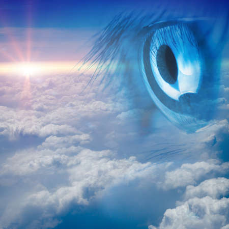 eye with blue sky white cloud backgroundの写真素材